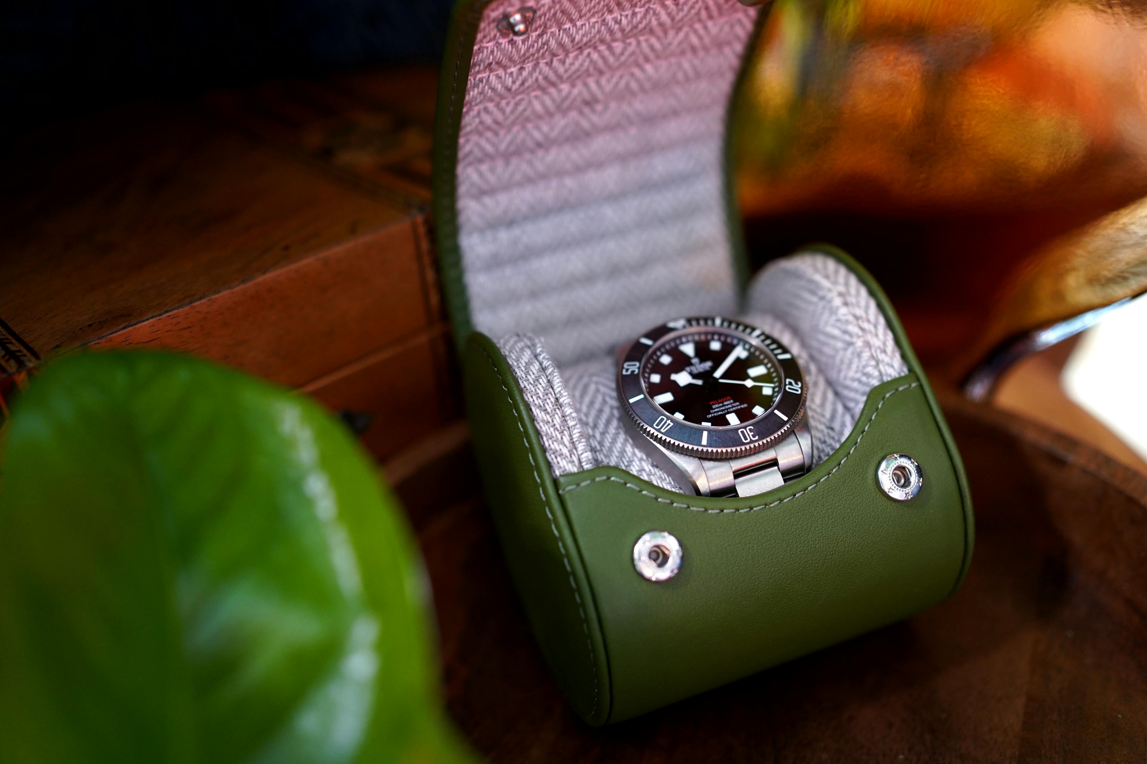 Introducing the Evergreen Luxury Watch Travel Roll – where timeless elegance meets impeccable craftsmanship. This exceptional case showcases a striking Green Leather exterior paired with a sophisticated Grey and White Chevron Patterned Interior, perfectly blending style and security for your cherished timepieces.

In this unique setting, envision our Evergreen case resting gracefully inside a cozy glamping teepee, surrounded by the rustic charm of the great outdoors. The lush green leather exterior embodies luxury, while the chevron patterned interior adds a touch of modern sophistication. Whether you're on a glamping adventure or simply seeking to protect your watches with utmost care, the Evergreen Luxury Watch Travel Roll is your ideal companion.

Explore a world where your watches travel in impeccable style, whether under the stars or in the comfort of your teepee, safe in the knowledge that every detail has been considered. Discover the essence of luxury and protection with our Evergreen case, redefining watch storage for the modern adventurer.