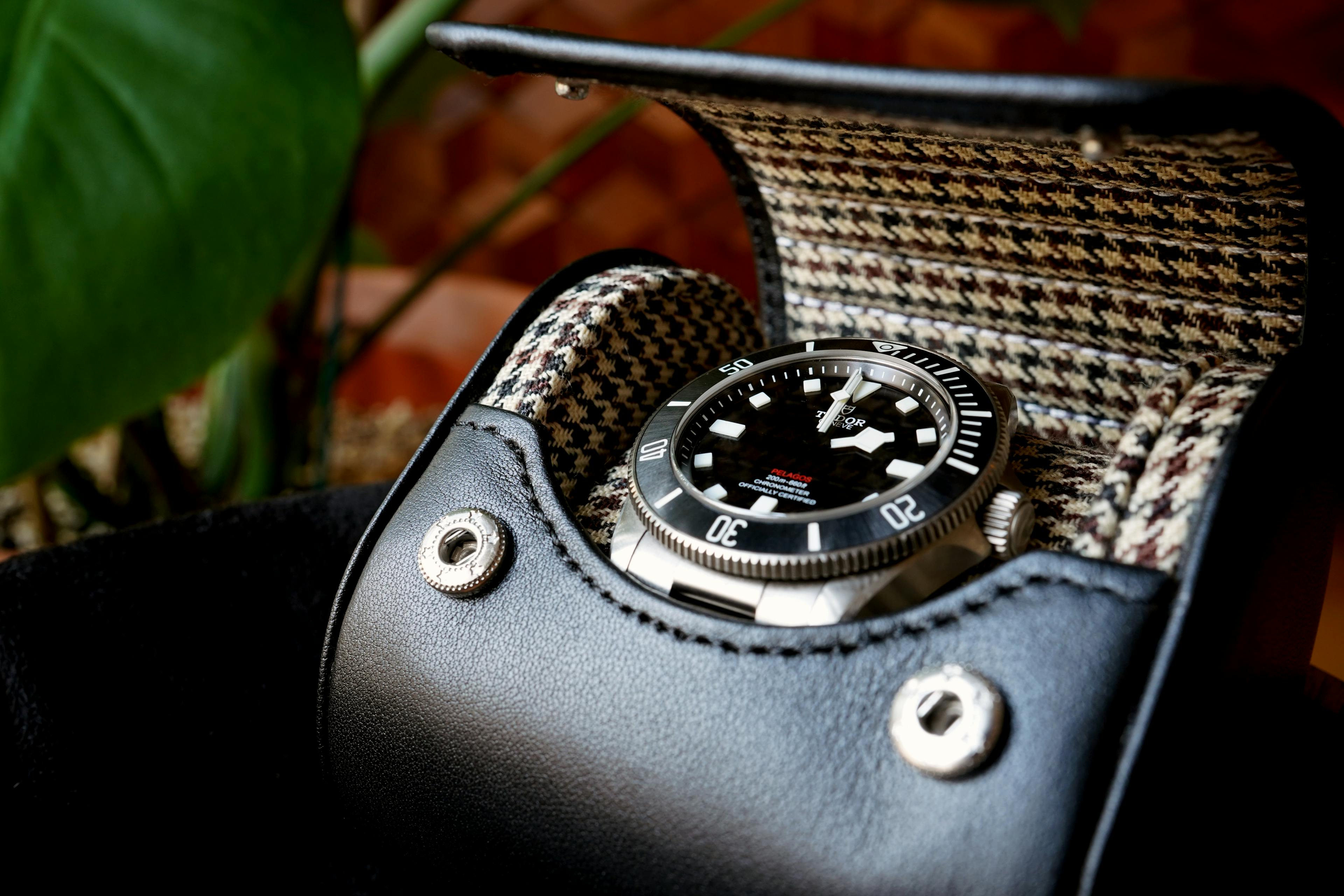 Elevate your watch collection to new heights of elegance with our Noir Luxury Watch Case. This exquisite case boasts a sleek Black Leather exterior paired with a sophisticated Brown and Black Tartan Interior, marrying style and protection seamlessly. Crafted with precision and passion, it's the ultimate guardian for your cherished timepieces.

In this timeless masterpiece, modern aesthetics blend effortlessly with classic design. The contrast between the rich black leather and the warm, inviting tartan interior creates an unforgettable visual. As you envision your watches nestled within, you'll appreciate the care we've taken to ensure both fashion and function are held in perfect balance.

Explore the world of luxury watch storage, where every detail is considered, and each watch finds its own cocoon of beauty and security. Whether for personal use or as an exceptional gift, our Noir case embodies the essence of sophistication and safeguarding. Discover the perfect companion for your watches today.